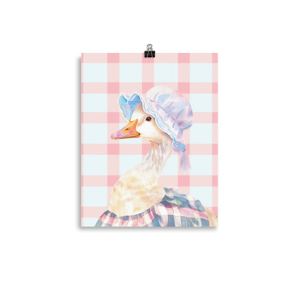  A charming duck, decked out in a cap and apron, set against a soft, plaid pink background that sings with sweetness. 